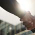 Handshake, meeting and business people in morning in city for career, job and work opportunity. Pro.